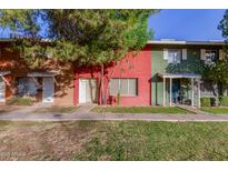 Two-story building with red and green painted brick exterior and grassy lawn at 6654 N 43Rd Ave, Glendale, AZ 85301