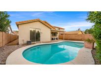 Inviting kidney-shaped pool in a backyard oasis at 6703 W Linda Ln, Chandler, AZ 85226