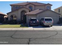 Two-story house with a large front yard and two-car garage at 7243 W Sandra Ter, Peoria, AZ 85382