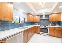 Modern kitchen with blue tile backsplash and stainless steel appliances at 7438 E Hum Rd # 101, Carefree, AZ 85377