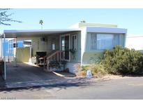 Inviting mobile home exterior, covered carport, and landscaping at 7807 E Main St # A-10, Mesa, AZ 85207