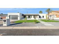 Modern house exterior with landscaped lawn and walkway at 9626 N 17Th Pl, Phoenix, AZ 85020