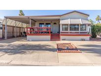 Single-wide mobile home with covered patio and carport at 17200 W Bell Rd # 439, Surprise, AZ 85374