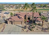 Single-story home with tile roof, desert landscaping, and a three-car garage at 18031 N Timber Ridge Dr, Surprise, AZ 85374