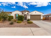 One-story home with desert landscaping, two-car garage, and neutral color palette at 18346 W Coolidge St, Goodyear, AZ 85395