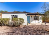 Charming single story home with light brick exterior and a blue front door at 1841 N 16Th Ave, Phoenix, AZ 85007