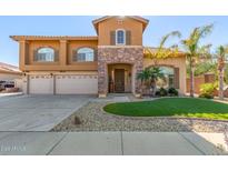 Two-story house with three-car garage and landscaped front yard at 2415 W Desperado Way, Phoenix, AZ 85085