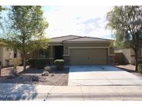 Single-story home with a two-car garage and desert landscaping at 38133 W Vera Cruz Dr, Maricopa, AZ 85138