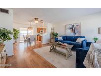 Bright living room with hardwood floors and comfortable blue sofas at 4205 E Calypso Ave, Mesa, AZ 85206