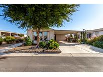 Mobile home with carport, landscaping, and spacious yard at 437 E Germann Rd # 24, San Tan Valley, AZ 85140