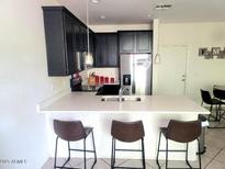 Modern kitchen with island and breakfast bar at 125 N Sunvalley Blvd # 102, Mesa, AZ 85207