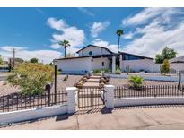 Stunning mid-century modern home with landscaped yard and walkway at 1401 W Ocotillo Rd, Phoenix, AZ 85013