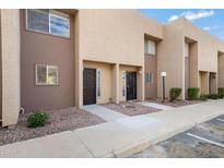 Tan two-story condo building with multiple units and landscaping at 1601 W Sunnyside Dr # 157, Phoenix, AZ 85029