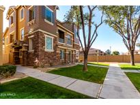 Exterior of a two-story townhome with stone accents and landscaping at 162 W Commerce Ct, Gilbert, AZ 85233