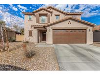 Two-story house with brown accents and a two-car garage at 16958 W Marconi Ave, Surprise, AZ 85388