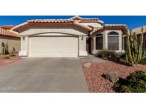 Single-story home with a two-car garage and desert landscaping at 2224 E Crest Ln, Phoenix, AZ 85024