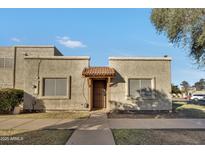 Cute stucco home with a Spanish-style entryway and landscaped yard at 3125 W Loma Ln, Phoenix, AZ 85051