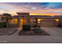 Beautiful desert landscaping surrounds this single-story home with a 3-car garage at 42585 W Heavenly Pl, Maricopa, AZ 85138