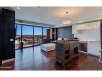 Modern living room with city views, hardwood floors, and comfortable seating at 4422 N 75Th St # 7011, Scottsdale, AZ 85251