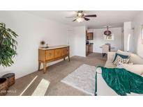 Bright living room with comfy seating and a view into the dining area at 5877 N Granite Reef Rd # 2212, Scottsdale, AZ 85250