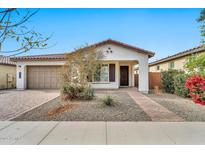 Single-story home with a two-car garage and landscaped front yard at 19436 S 208Th Pl, Queen Creek, AZ 85142
