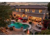 Luxury home with pool and landscaped backyard at dusk at 32009 N 19Th Ln, Phoenix, AZ 85085