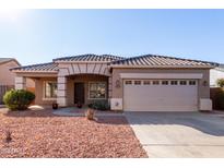 One-story house with tan exterior, tile roof, and a two-car garage at 4233 E Colonial Dr, Chandler, AZ 85249