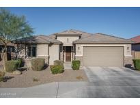 Single-story home with a two-car garage and well-manicured landscaping at 7332 W Quail Track Dr, Peoria, AZ 85383