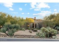 Spanish style home with landscaped desert front yard at 10175 E Winter Sun Dr, Scottsdale, AZ 85262