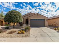 Single-story home with desert landscaping and two-car garage at 21271 N 262Nd Dr, Buckeye, AZ 85396