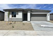 Charming single-story home featuring neutral stucco, gray trim, and a well-manicured gravel yard at 24098 W Sunland Ave, Buckeye, AZ 85326