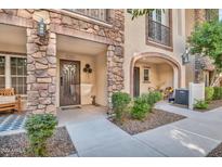 Inviting exterior of townhome with stone accents and landscaped walkway at 2458 E Roma Ave, Phoenix, AZ 85016