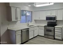 Bright kitchen features modern appliances and updated countertops at 2802 W Michelle Dr, Phoenix, AZ 85053