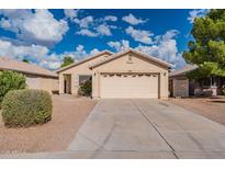 Single-story home with attached garage and landscaped front yard at 3555 S Moccasin Trl, Gilbert, AZ 85297