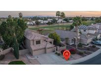 Expansive aerial view of a well-manicured home backing up to a golf course and community at 5951 W Irma Ln, Glendale, AZ 85308