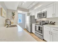 Modern kitchen with stainless steel appliances and white cabinets at 7950 E Starlight Way # 220, Scottsdale, AZ 85250