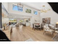Open floor plan living room, dining area, and kitchen with high ceilings and hardwood floors at 7956 E Via Costa --, Scottsdale, AZ 85258