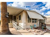 Inviting single-wide manufactured home with covered porch and landscaped yard at 9333 E University Dr # 55, Mesa, AZ 85207