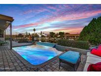 Relaxing backyard oasis with a sparkling pool, patio furniture, and water views at 1412 E Commodore Pl, Tempe, AZ 85283