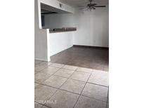 Kitchen features gray cabinets, tile flooring and modern appliances at 18202 N Cave Creek Rd # 128, Phoenix, AZ 85032