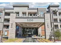 The Luxe 5250 building entrance, featuring a modern design with stone accents and water feature at 5250 E Deer Valley Dr # 450, Phoenix, AZ 85054
