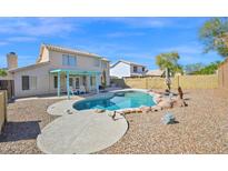 Inviting backyard pool with rock accents and a charming pergola, perfect for outdoor relaxation and entertainment at 659 S Dodge St, Gilbert, AZ 85233