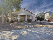 One-story home with landscaped front yard and stone pathway at 14335 W Country Gables Dr, Surprise, AZ 85379