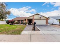 House exterior showcasing a well-maintained lawn, driveway, and basketball hoop at 1449 W Mohawk Ln, Phoenix, AZ 85027