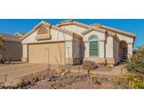 One-story house with landscaped yard and two-car garage at 18208 W Skyline Dr, Surprise, AZ 85374