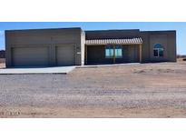 Two-car garage and desert landscaping surround this one-story home at 24301 N 194Th Ave, Surprise, AZ 85387