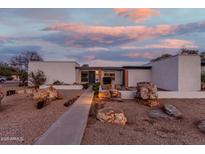 Mid-century modern home with landscaped yard and unique rock features at 2609 S Country Club Way, Tempe, AZ 85282
