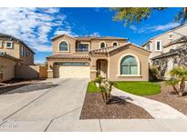 Two-story house with a tan facade, arched windows, and a three-car garage at 2838 E Shady Spring Trl, Phoenix, AZ 85024