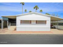 Mobile home with carport and palm trees at 305 S Val Vista Dr # 417, Mesa, AZ 85204
