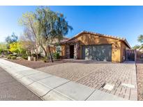 Single-story home with a two-car garage and landscaped front yard at 31310 N 26Th Dr, Phoenix, AZ 85085